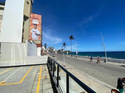 a street with a sign on the side of a beach at Studio charmoso no coração da Barra in Salvador