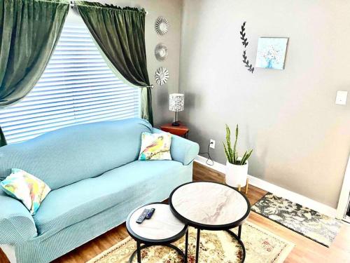 a living room with a blue couch and a table at Renasant Convention 5 mins-shuttle to down town- Regional One-UT Health-Methodist University-Lebonheur Hospital in Memphis