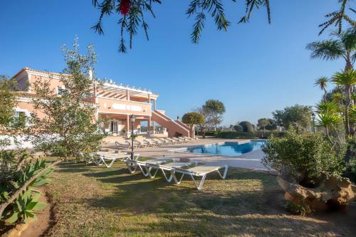 a resort with a swimming pool and a building at Al Meida Guesthouse in Albufeira