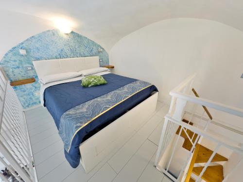 a small bedroom with a bed and a staircase at Alfieri Rooms - Amalfi coast in Atrani