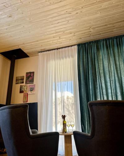 a living room with a table and a window at In The Forest in Mestia