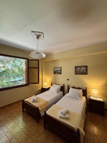 a bedroom with two beds and a window at The Knights Courtyard in Rhodes Town