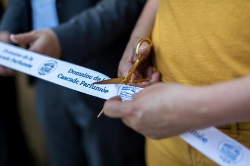 a person cutting a piece of paper with scissors at Domaine de la Cascade Parfumée in Grasse