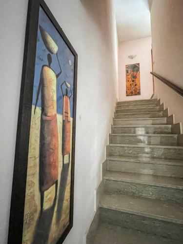 a painting on the wall next to a staircase at La Piazzetta in Torella deʼ Lombardi