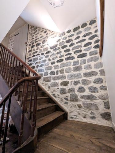 a staircase with a stone wall at Gîte XIIIème siècle - 3 étoiles - WIFI - Salle de sport in Osse-en-Aspe