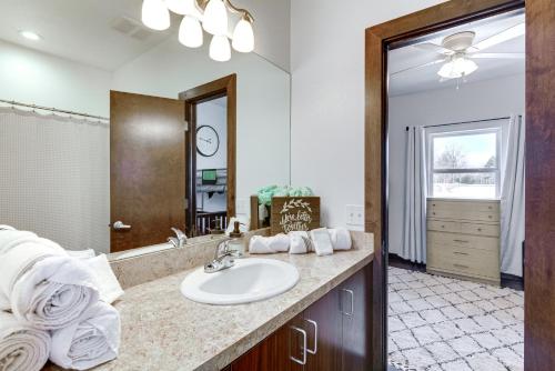 a bathroom with a sink and a mirror at Marionville Cottage on 70 Acres with Recreation Room 