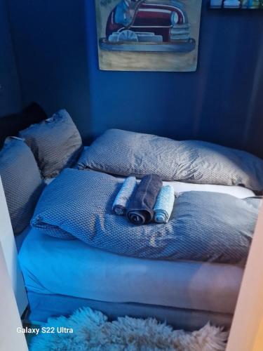 a bed with two pillows on top of it at Sjarmerende leilighet i hjerte av Tønsberg by in Tønsberg