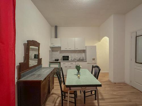 a kitchen with a table and chairs in a room at Charmant Studio avec Balcon in Perpignan