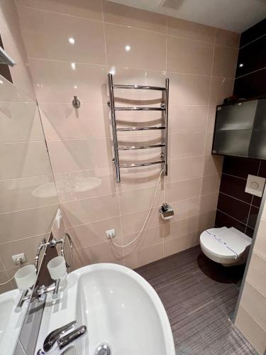 a bathroom with a white tub and a toilet at Апартаменты на Данилевского in Kharkiv