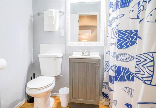 a bathroom with a toilet and a sink and a shower curtain at Tribesman #16 - Margo Polo - near Silver Dollar City in Branson