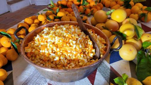 a bowl of corn sitting on a table with fruit at Domaine de la Cascade Parfumée in Grasse