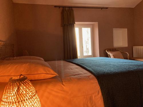 a bedroom with a large bed and a window at Casa 55 in Tulette