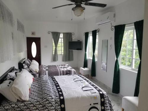 a bedroom with a bed and a ceiling fan at Thebreeze can accommodate up to 30 people 