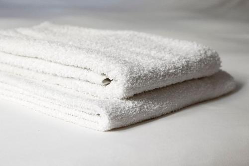 three white towels stacked on top of each other at Venice-Flat 75m² perfect for 2 couples (free Park) in Mestre