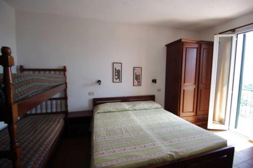 a small bedroom with a bed and a window at AGRITURISMO LA FATTORIA in Ranzo-Borgo