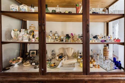 a glass cabinet filled with lots of items at Domaine de la Cascade Parfumée in Grasse