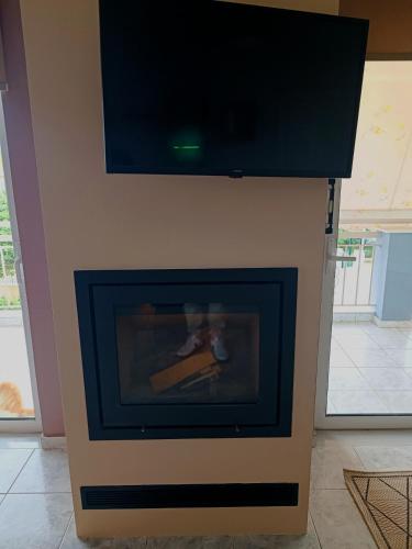 a fireplace with a tv on top of it at Rea's House Vrachati in Vrahati