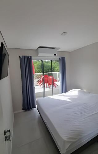 Кровать или кровати в номере Quartos Confortáveis - 5 min Aeroporto Internacional