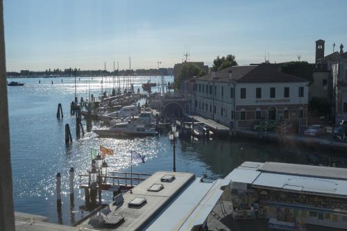 a view of a marina with boats in the water at Hotel Grande Italia in Chioggia