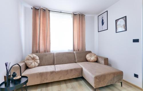 a living room with a couch and a large window at 6 Bedroom Stunning Home In Podgrade in Tugonica
