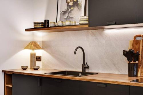 a kitchen with a sink and a lamp on a counter at Appartement de Luxe 2BDR/7P - Louvre/tuileries in Paris