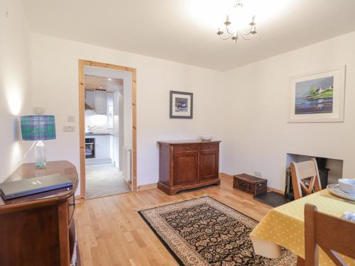 a living room with a table and a dining room at Tigh a Phailean in Letterfearn