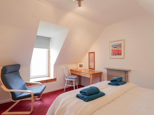 a bedroom with a bed and a chair and a desk at Tigh a Phailean in Letterfearn