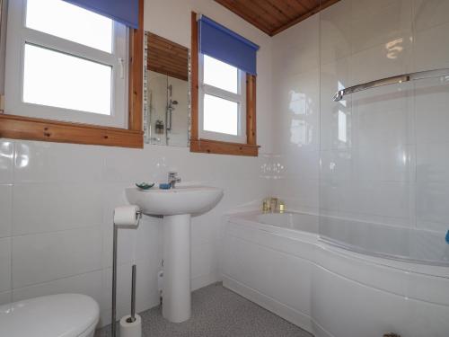 a bathroom with a sink and a toilet and a tub at Tigh a Phailean in Letterfearn