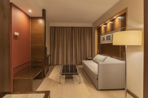a hotel room with a couch and a table at Exe León in León