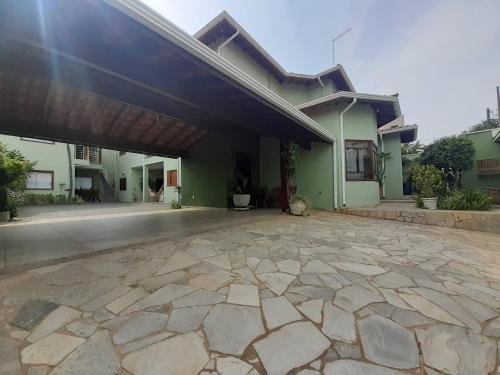 a house with a stone patio in front of it at Hotel Vila Solar in Limeira