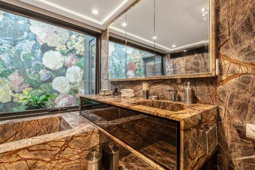 a bathroom with a sink and a large window at Carlton Luxury Kings Mansion - 5min to CBD, Garage and Rooftop in Melbourne