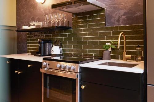 a kitchen with a stove and a sink at The Dorchester Hotel in Collingwood