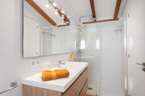 a bathroom with a sink and a shower at S'Embat sea views in Alcudia