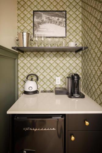 a kitchen counter with a coffee maker on top of it at The Dorchester Hotel in Collingwood