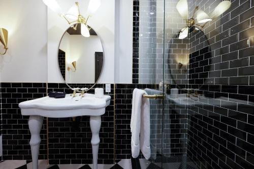 a bathroom with a white sink and a mirror at The Dorchester Hotel in Collingwood