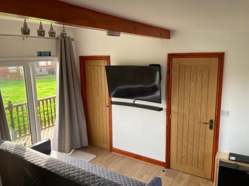 a living room with a refrigerator and a door at 2BR-Sleeps3-Parking-NearBeach in Mablethorpe