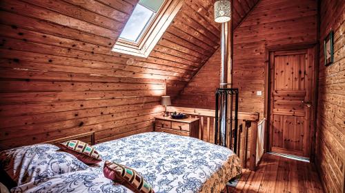a bedroom with a bed in a wooden room at The New Farmhouse in Biggar