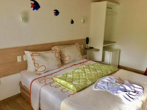 a bedroom with a bed with butterflies on the wall at Pousada Suiça in Santa Leopoldina