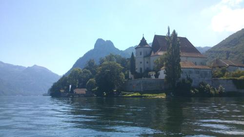 a castle sitting on the shore of a body of water at Bernhard Schmidt-Gasse in Gmunden