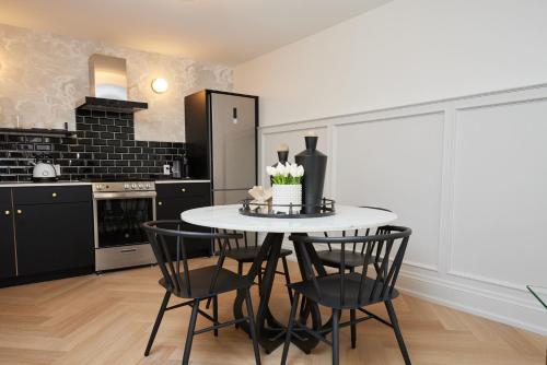 a kitchen with a table and chairs in a room at The Dorchester Hotel in Collingwood