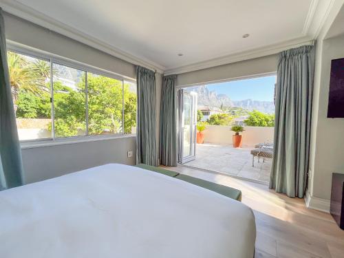 a bedroom with a large bed and a large window at Vetho Villa in Cape Town