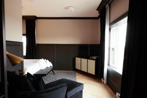 a living room with a couch and a chair at The Dorchester Hotel in Collingwood