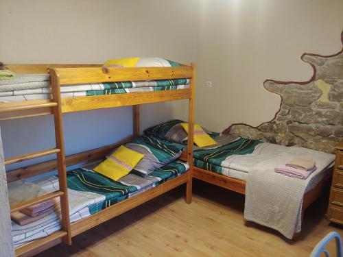 a room with two bunk beds and a bed at Agroturystyka Zacisze in Gorzanów