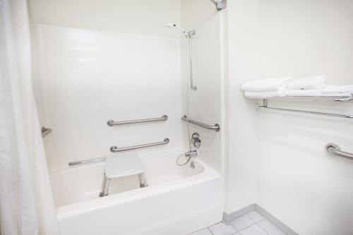 a bathroom with a tub and a shower at Super 8 by Wyndham West Branch in West Branch