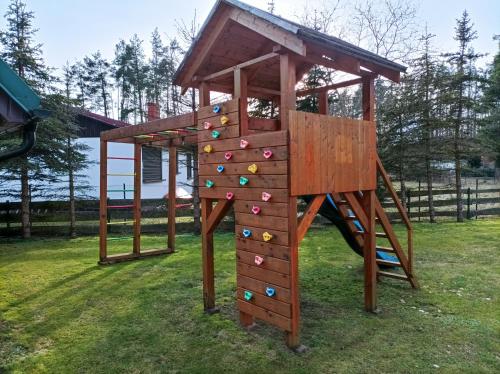 a playground with a climbing frame and a ladder at Zielona Zagroda in Borek