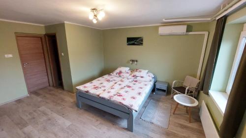 a small bedroom with a bed with pink sheets at miniSZILVA Apartman in Balatonalmádi