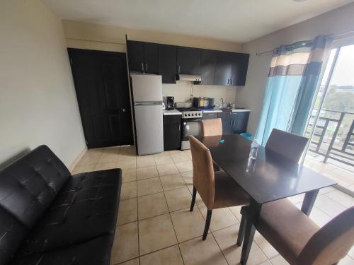 a kitchen and dining room with a table and chairs at Departamentos velasco Planta baja in Tijuana