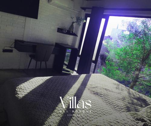 a bedroom with a bed and a large window at Villas del Bosque in El Pueblito