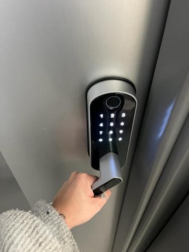 a person holding a hair dryer on a wall at Rambla Alicante Contactless in Alicante