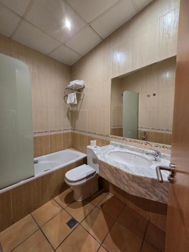 a bathroom with a tub and a toilet and a sink at Rambla Alicante Contactless in Alicante